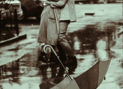 a romantic couple kissing in the rain